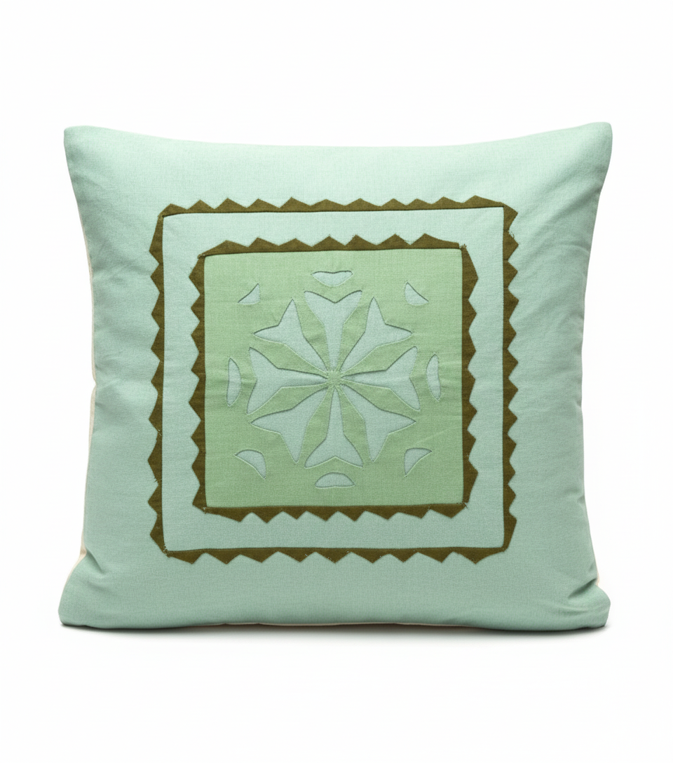 Light blue pillow with a decorative brown border and central pattern on a white background