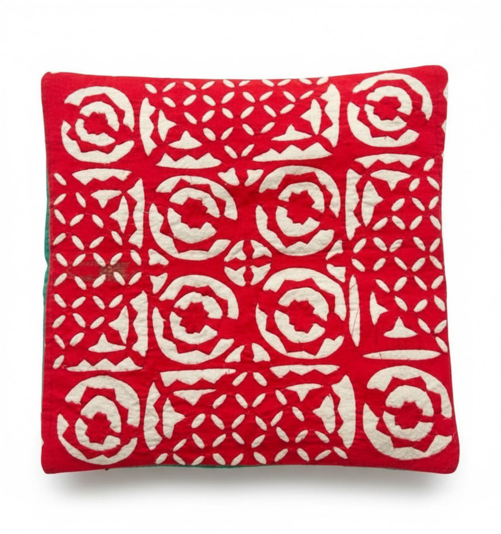 Red fabric with white geometric pattern on a dark surface