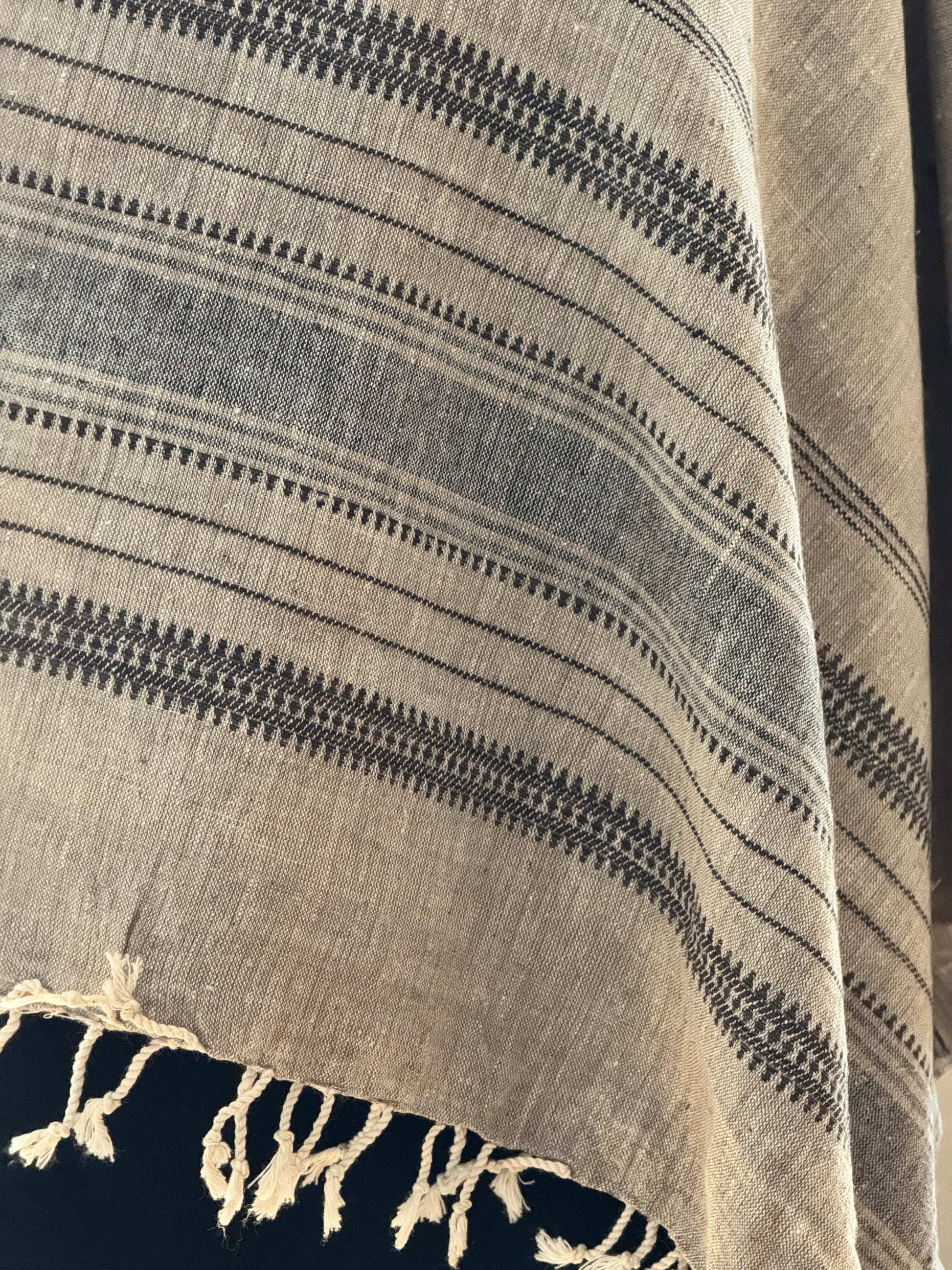 Textured beige cotton stole with black pattern and frayed edge