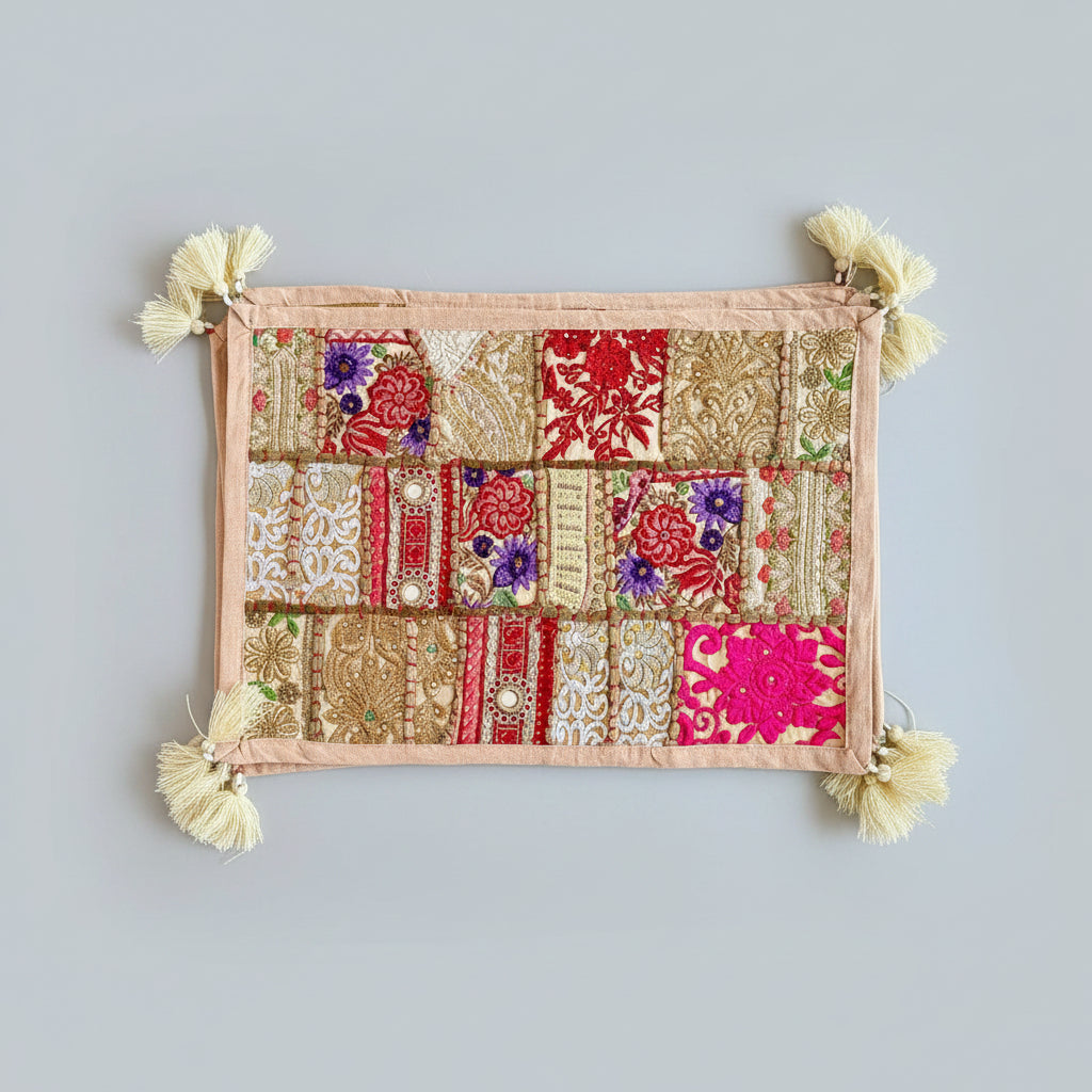 Decorative Khambhadia patchwork placemats with floral and geometric patterns on a dark background