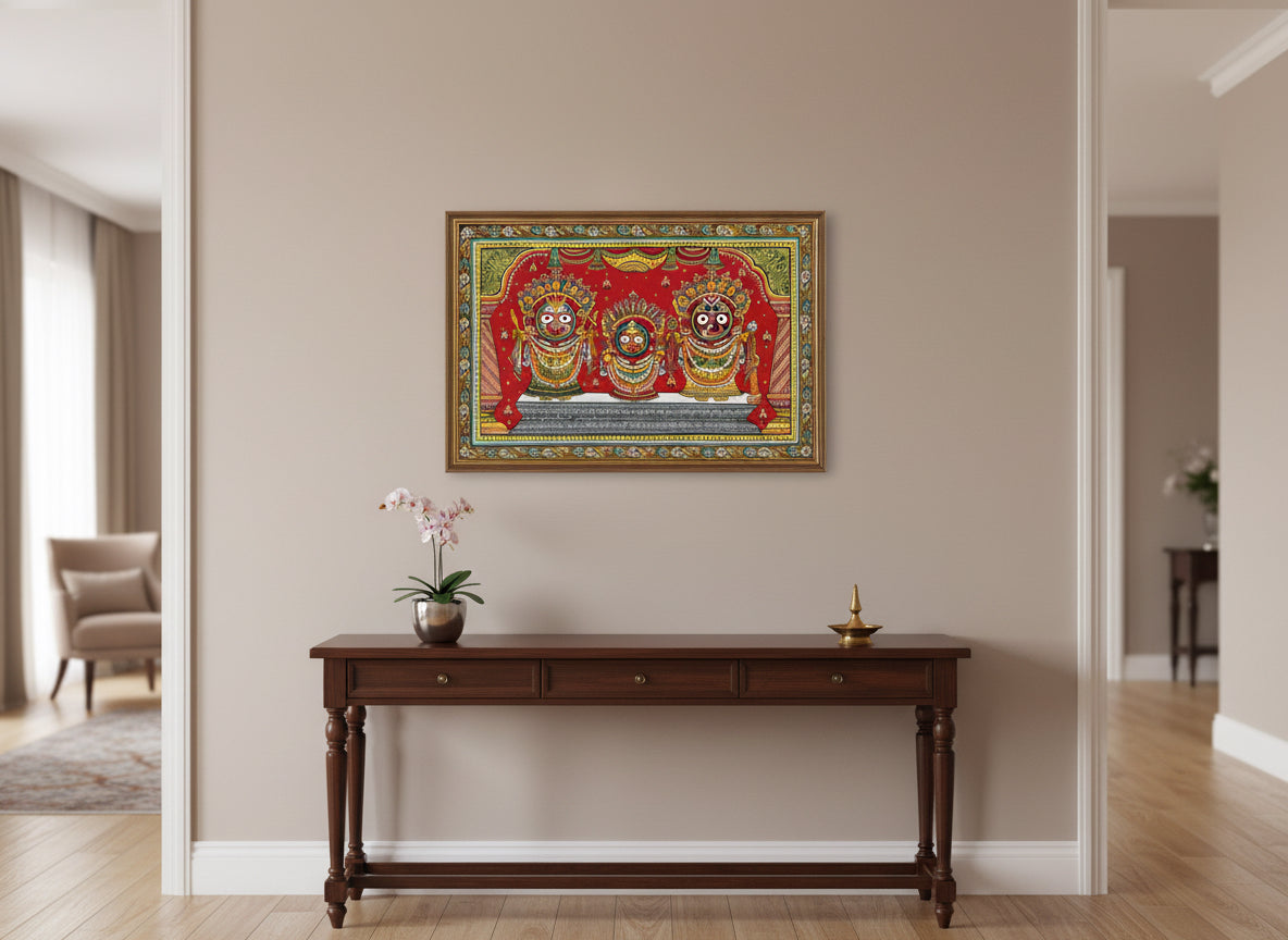 Decorative artwork panel with three deities in ornate attire on a red background