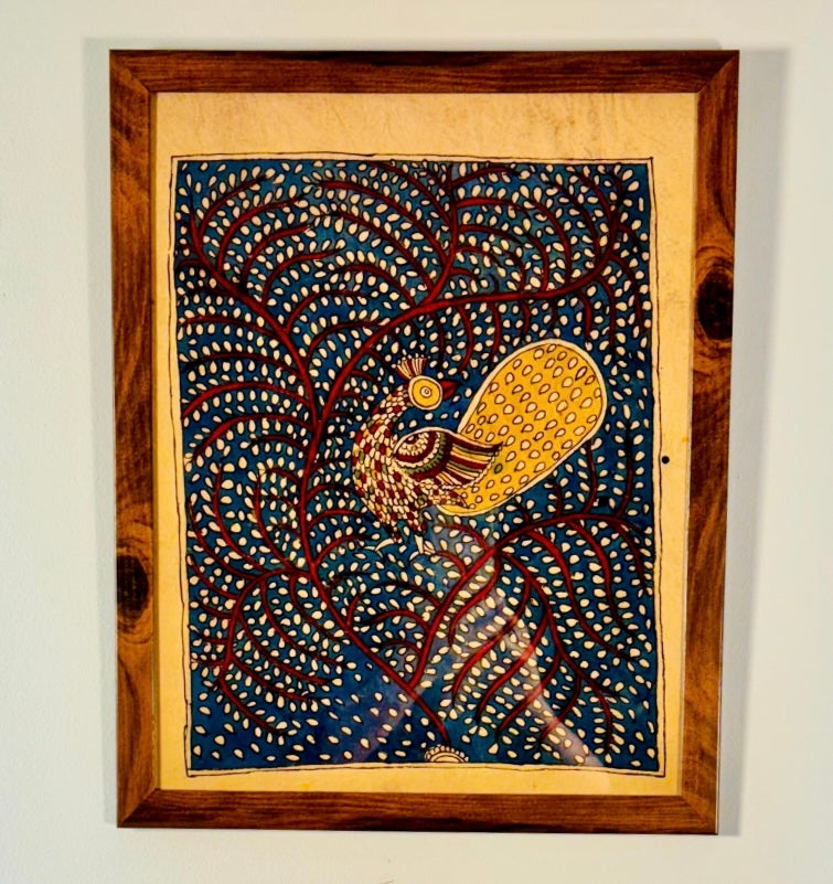 Framed artwork of a peacock with intricate patterns on a blue background.