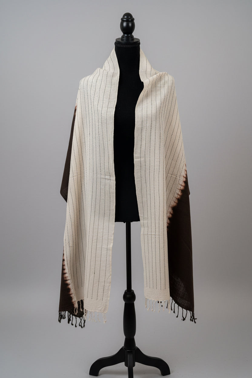 Mannequin wearing a black and white striped scarf on a gray background