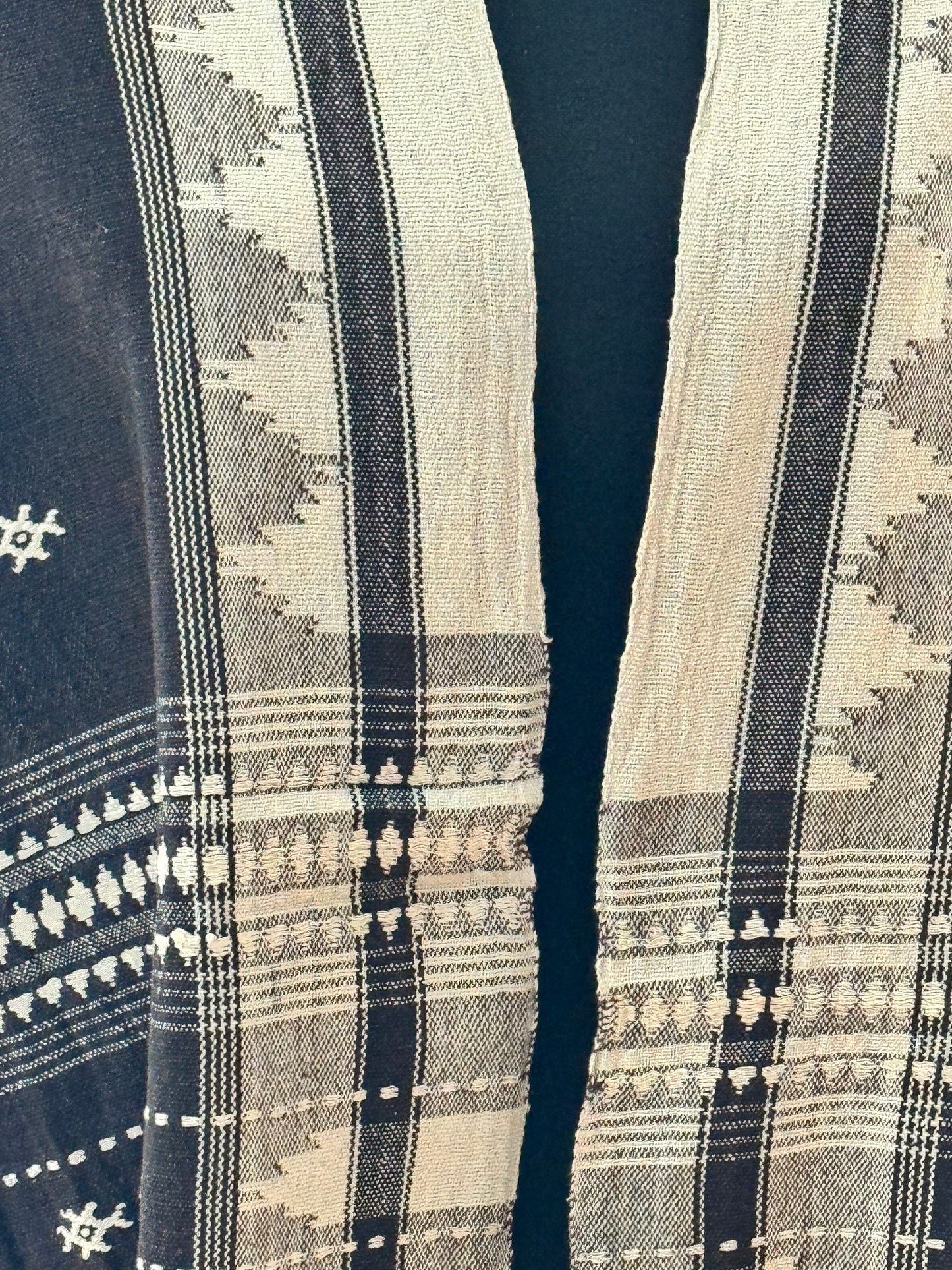Close-up of patterned Kotpad cotton stole with geometric designs on a dark background