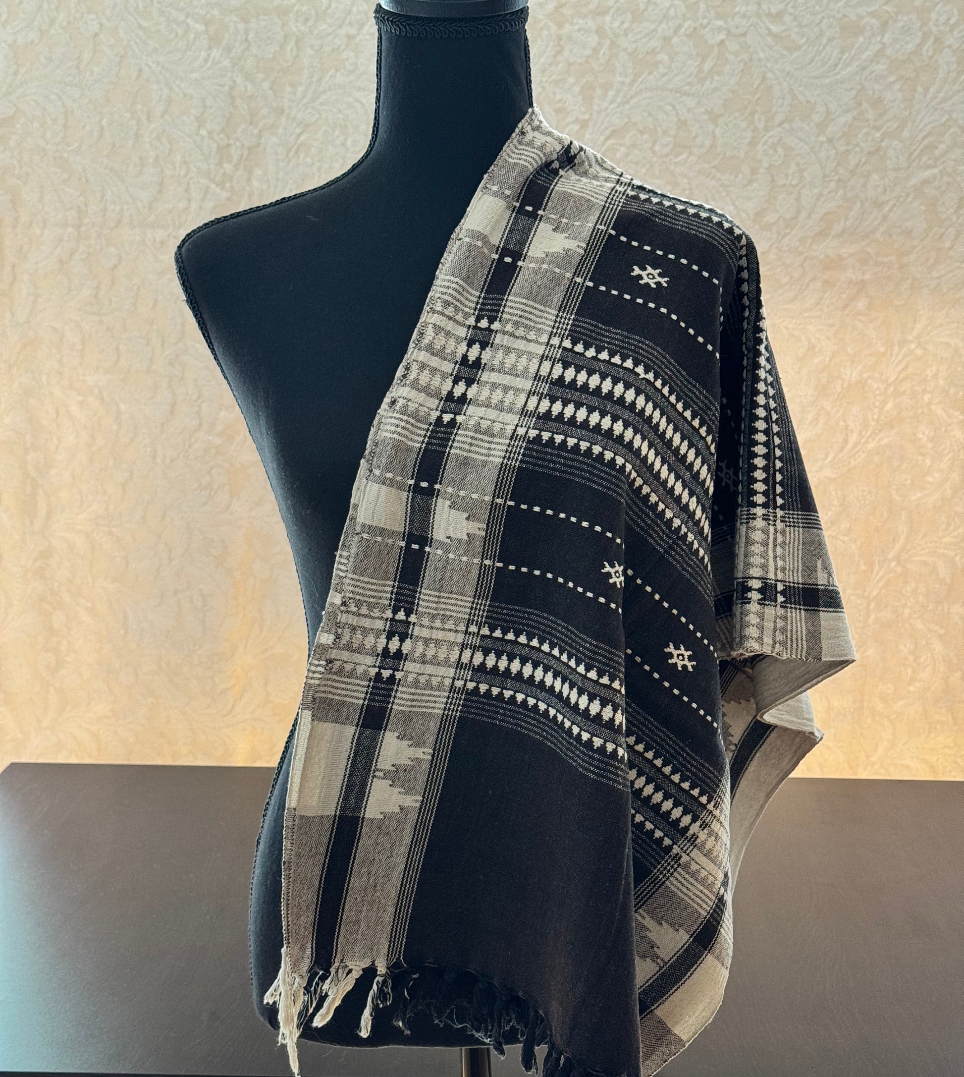 Blue and white patterned Kotpad weave scarf draped over a mannequin against a neutral background
