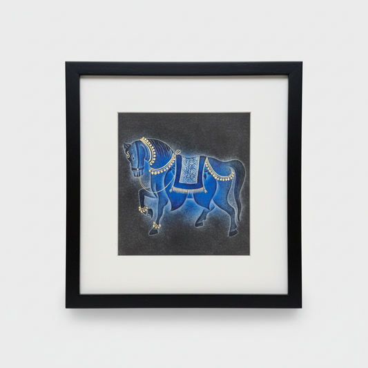 Framed nail drawn artwork of a blue horse with gold details on a white background