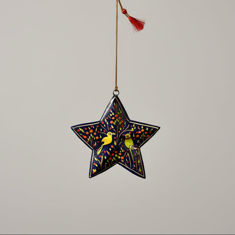 Decorative star ornament with birds hanging from a woven basket.