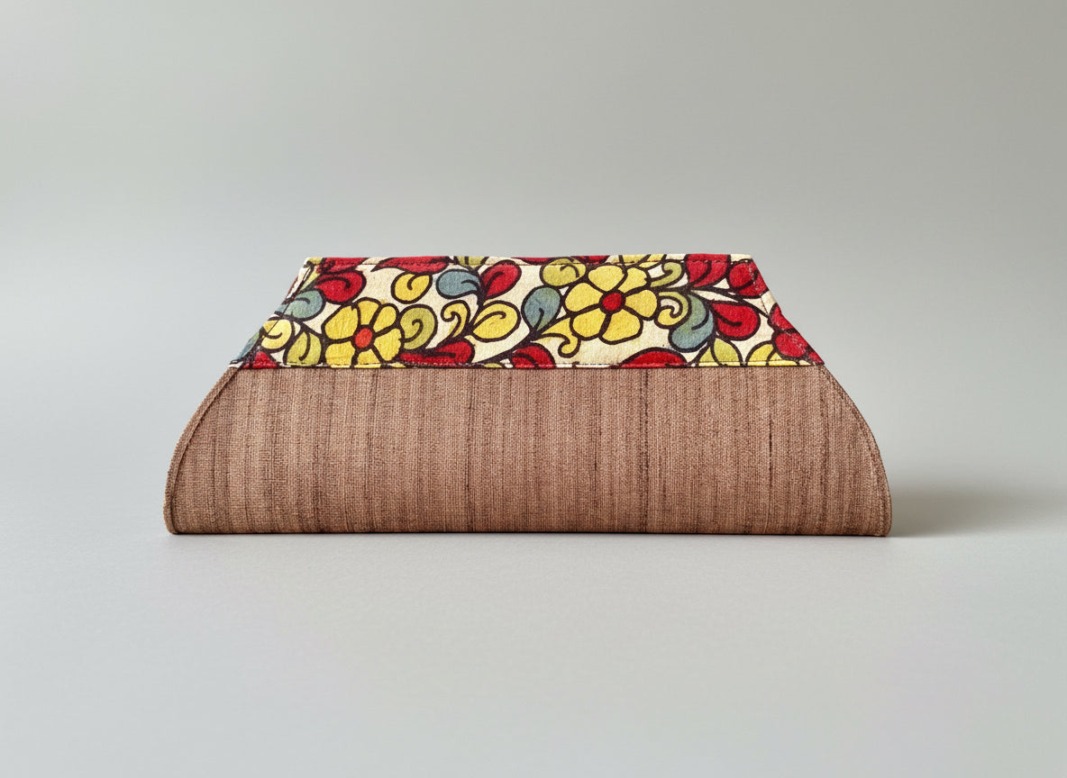 A collection of hand-painted kalamkari clutch purses in various colors, featuring intricate patterns.