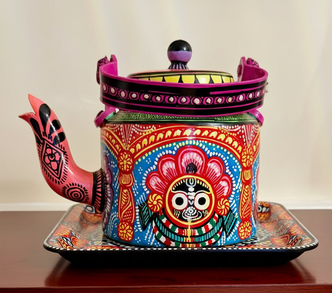 Colorful decorative teapot with intricate patterns on a wooden surface.