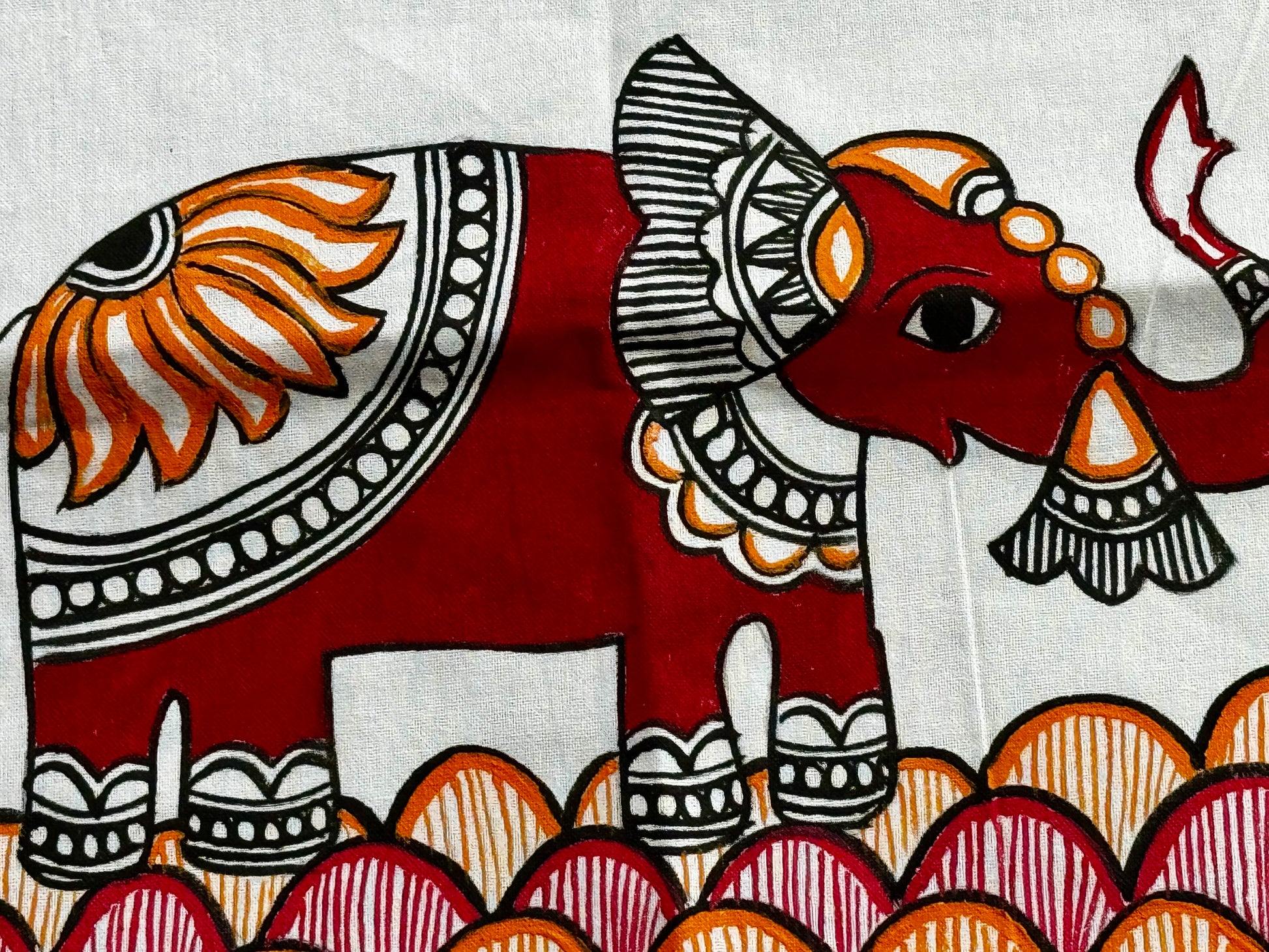 Decorative illustration of an elephant with intricate patterns on a white background