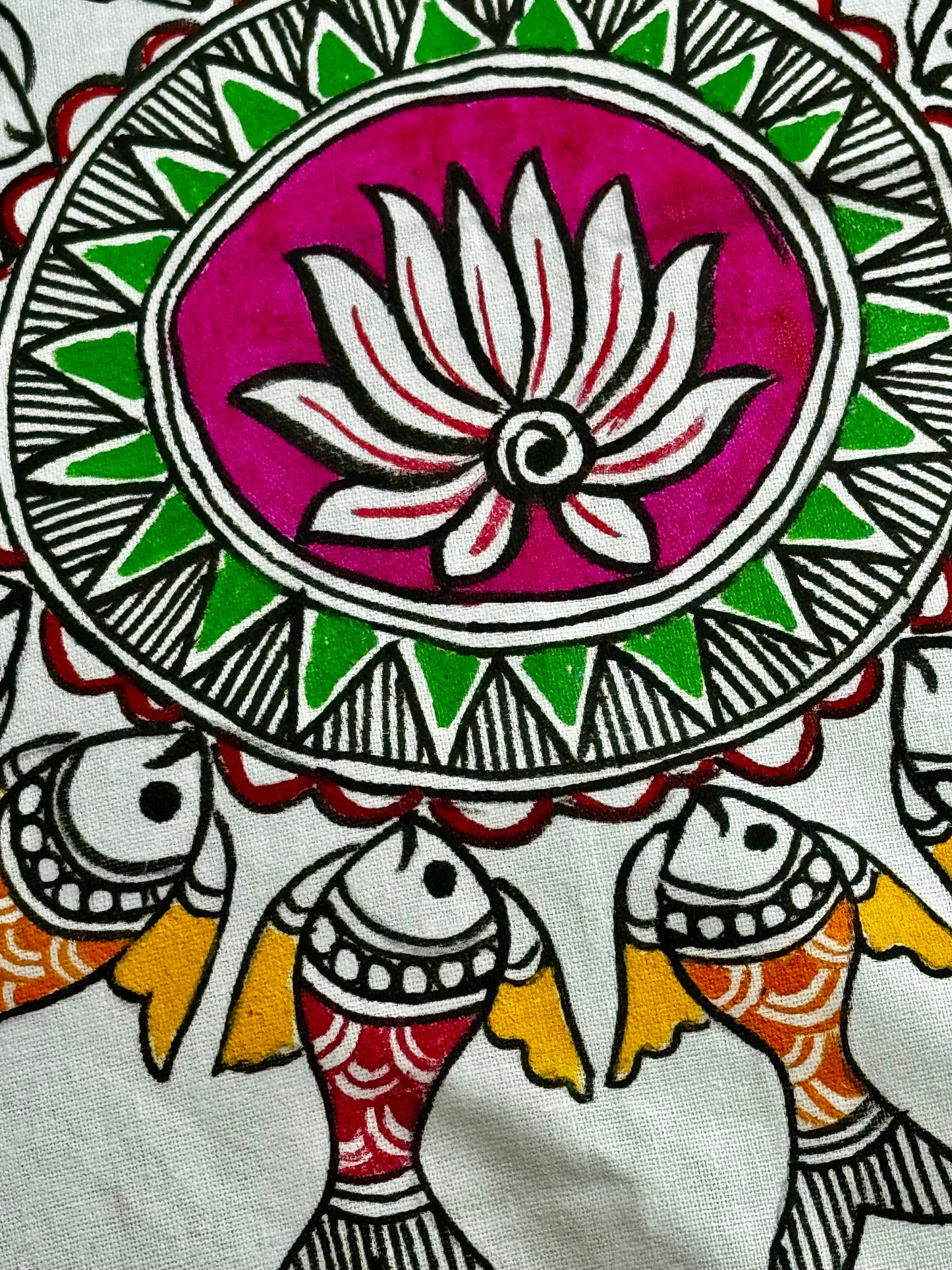 Close up of Decorative Madhubani art design with lotus flower and fish, featuring a pink lotus on a white background.