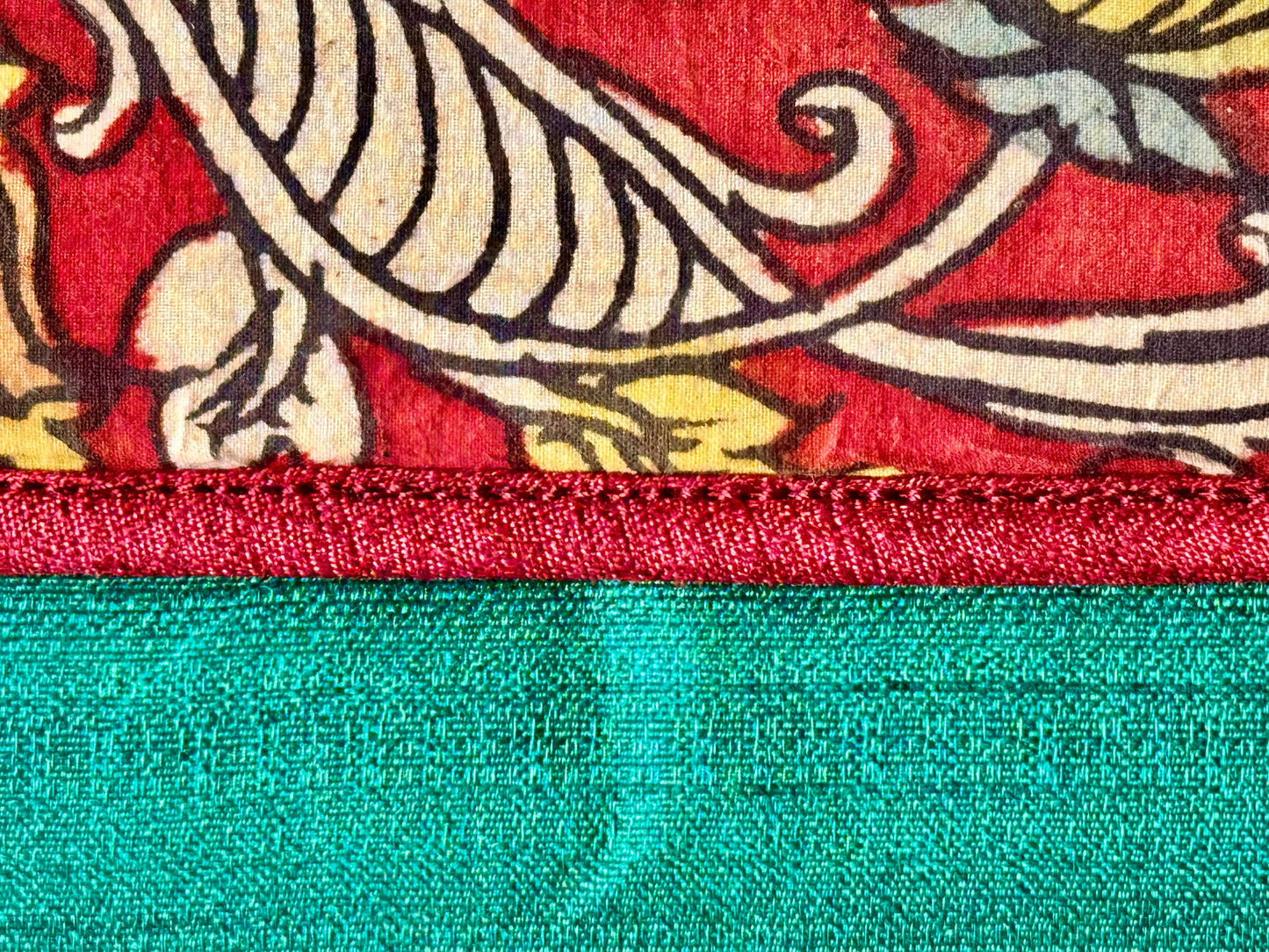 Authentic Kalamkari fabric evening clutch featuring vibrant hand-painted Indian motifs and artisanal detailing. Close up of the hand painted clutch