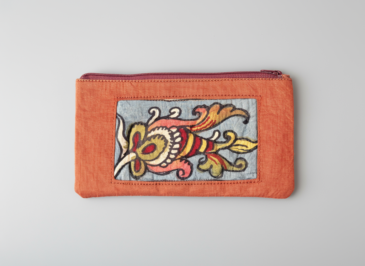 Small orange pouch with floral embroidery on a gray background
