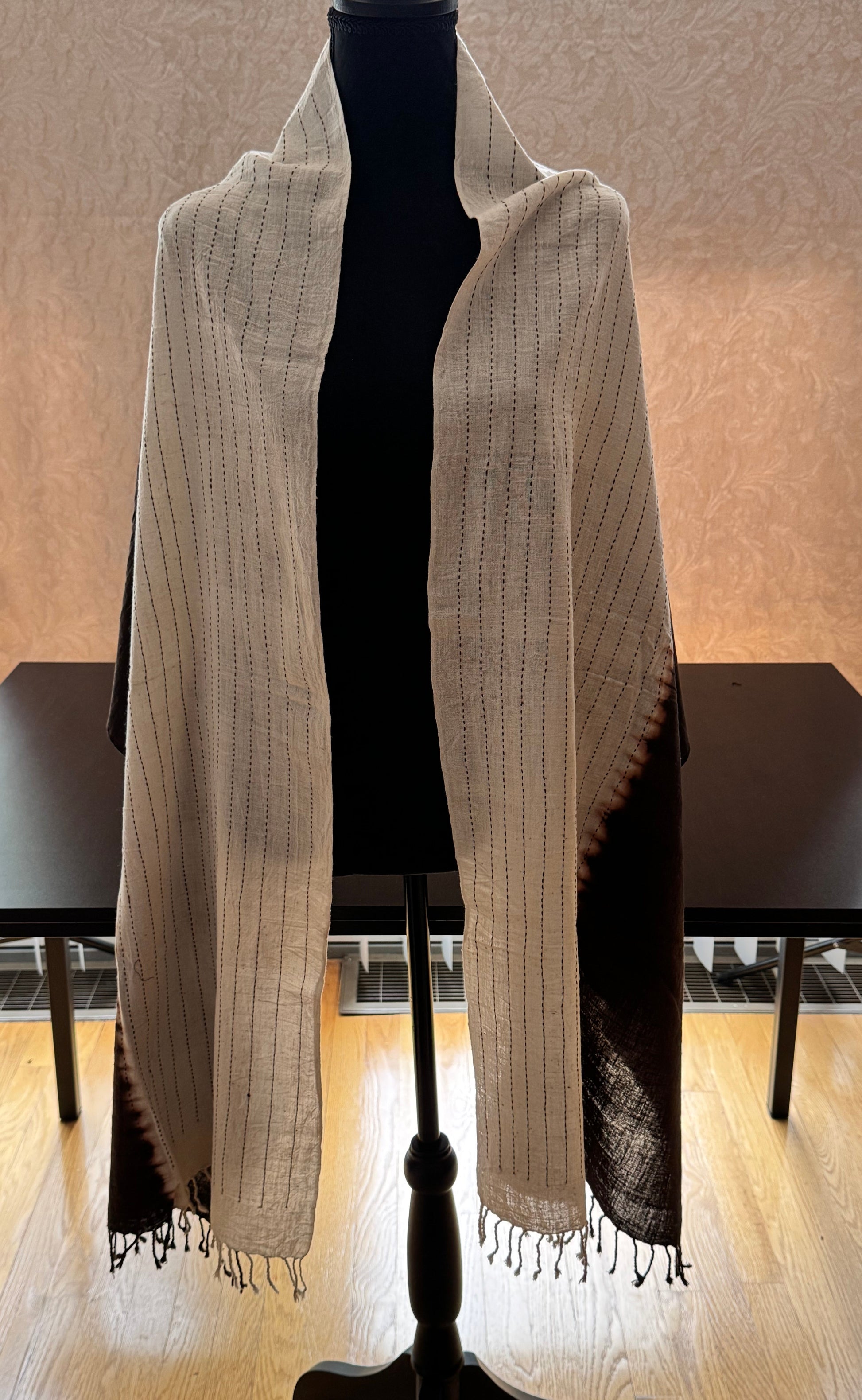 Mannequin wearing a beige and black half and half cotton stole
