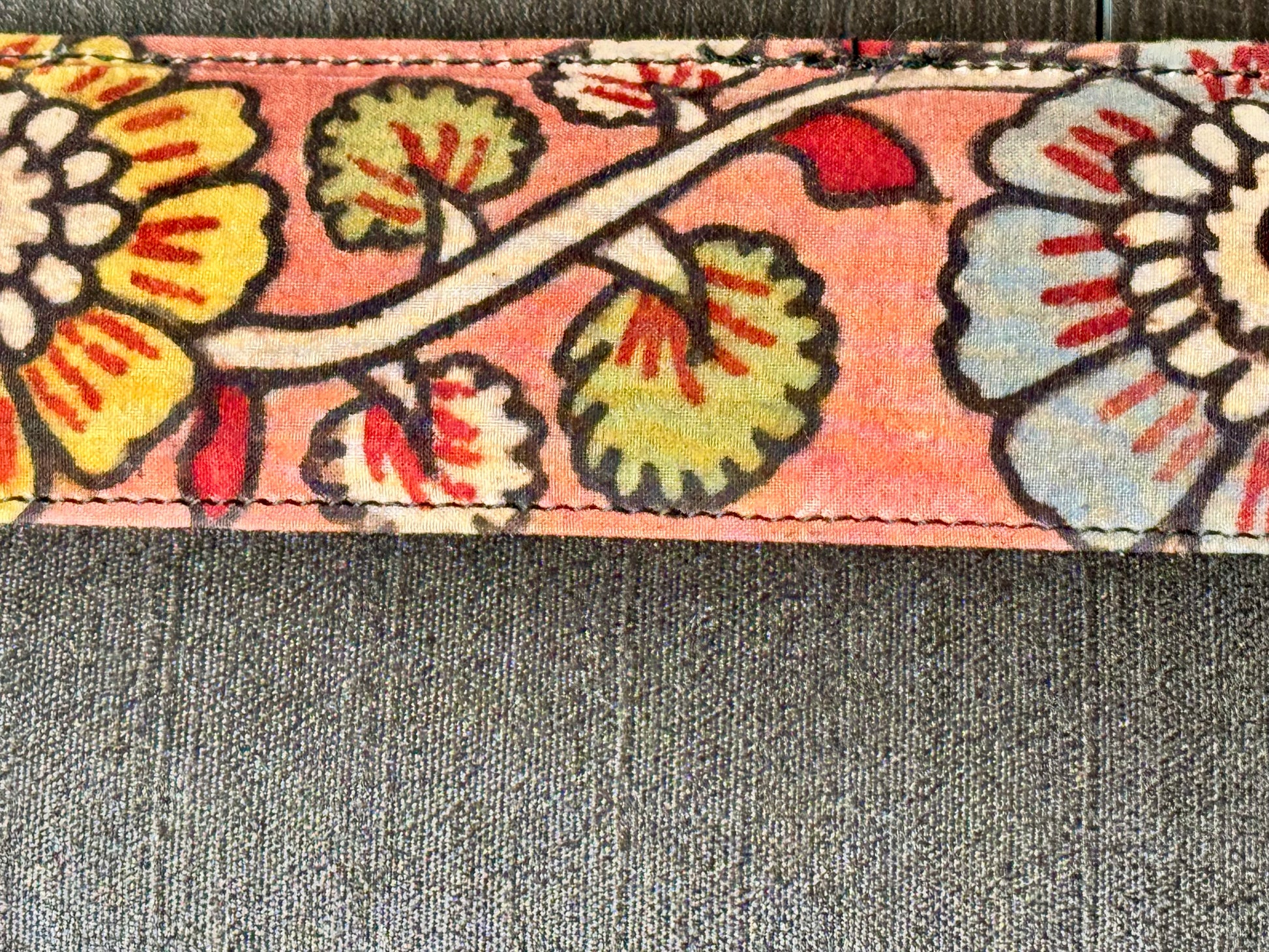 Close up of black raw silk hand painted Kalamkari clutch bag