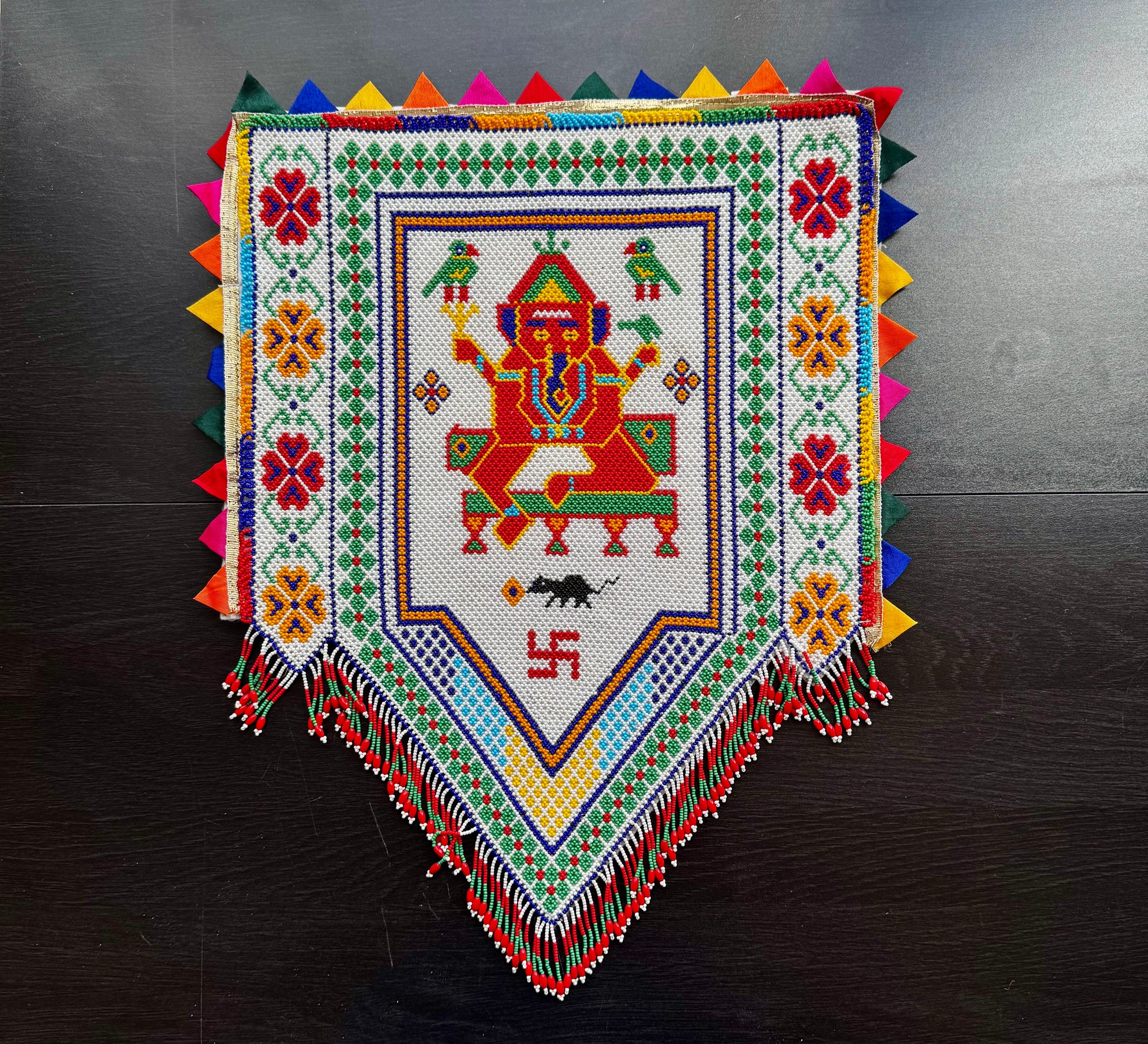 Colorful Ganesh In  Motikaam with intricate patterns on a dark surface