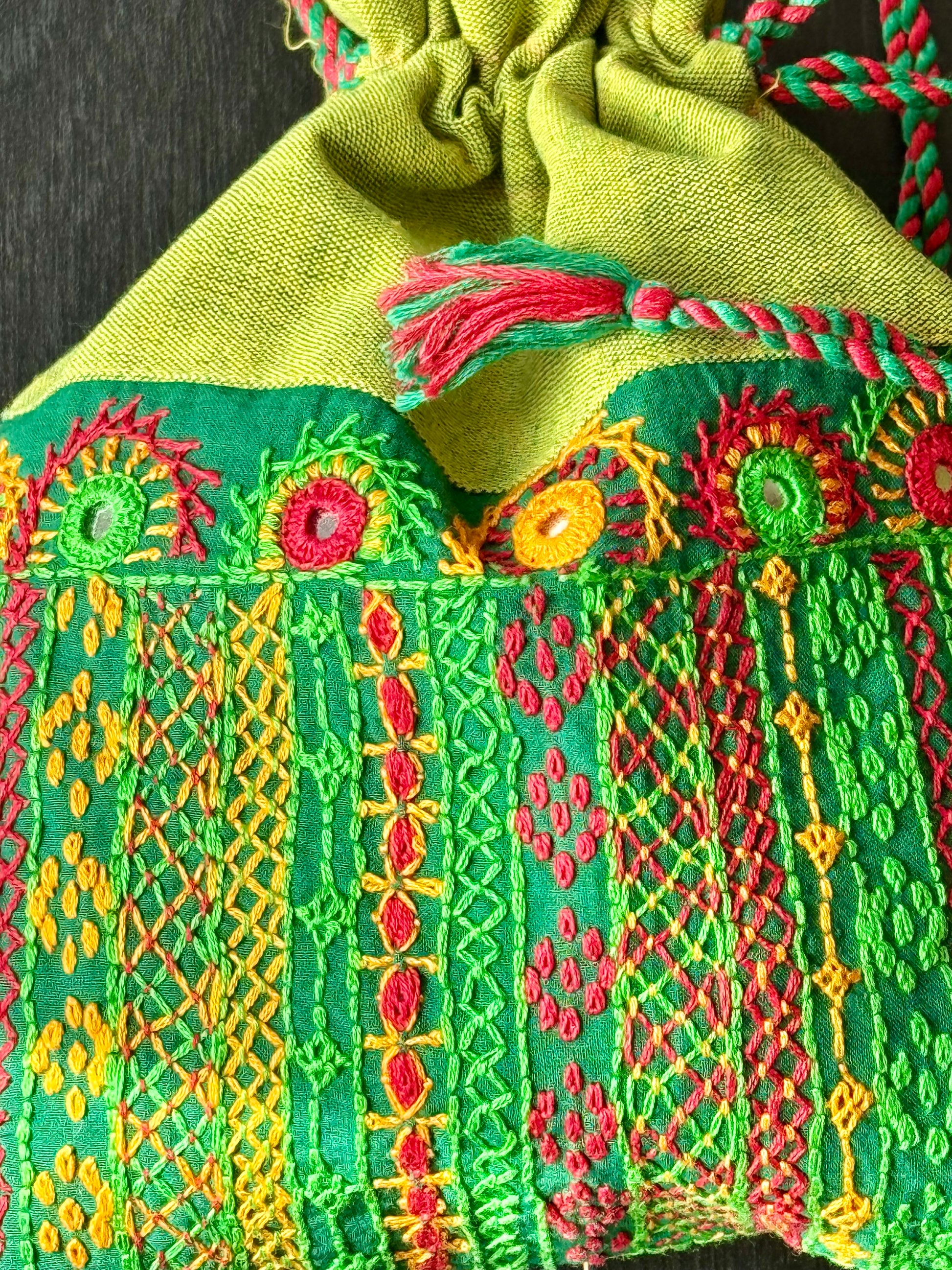 Close up of green Batwa with Lambani work