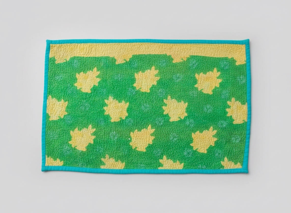 Green Kantha work placemats with yellow leaf pattern on a black background