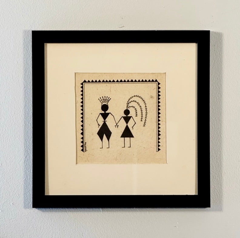 Framed artwork with black and white design on a beige background
