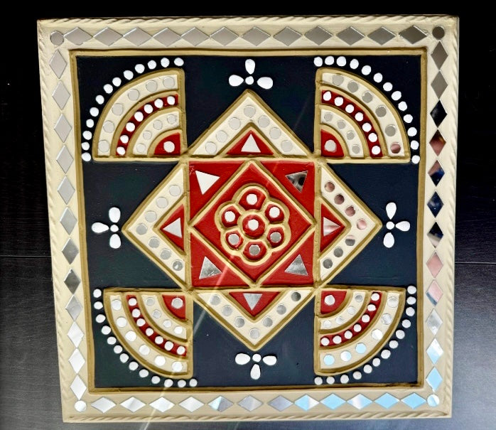 Decorative mosaic tile with geometric pattern on a dark background