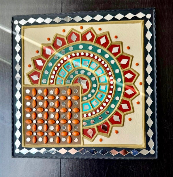 Decorative tile with geometric pattern on a dark surface