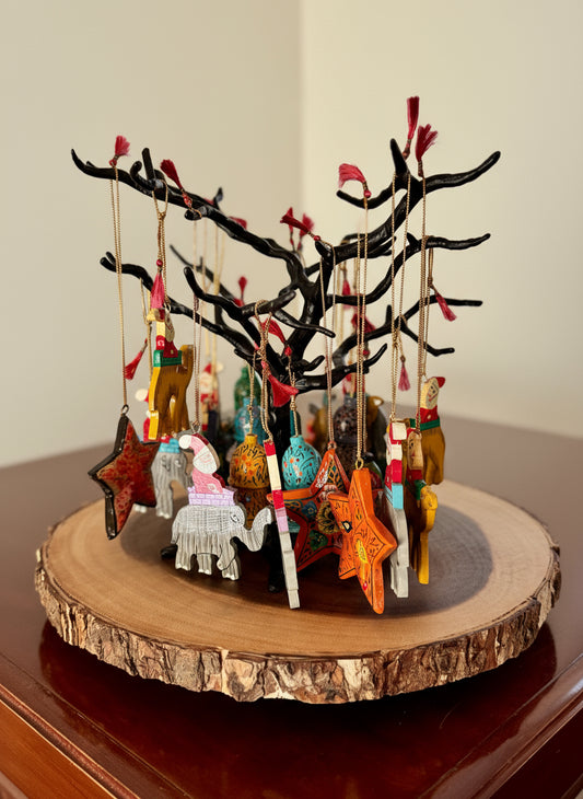 Decorative tree with hanging ornaments on a wooden base
