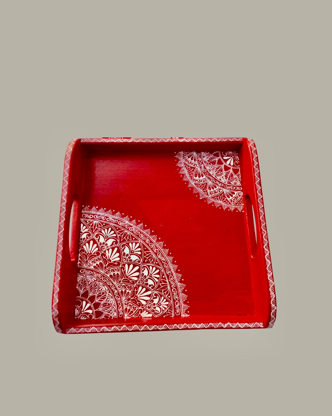 Red decorative tray with Aipan art white lace patterns on a gray background