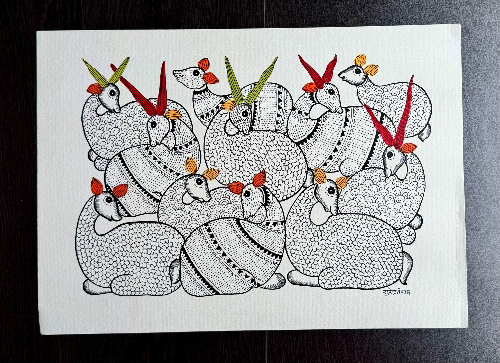 Gond Art painting of a group of stylized animals with colorful horns on a white background.
