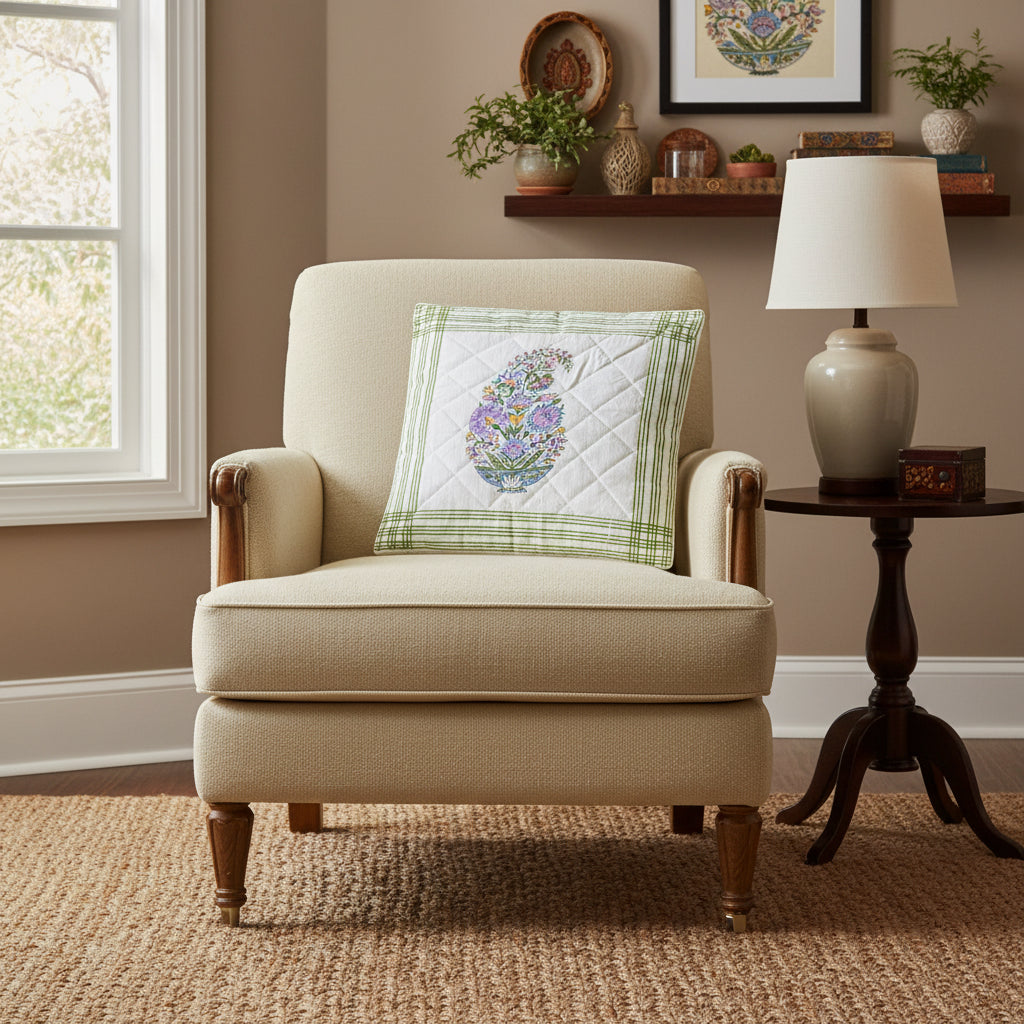 Quilted square cushion cover with hand block printed floral design and green border on a dark surface