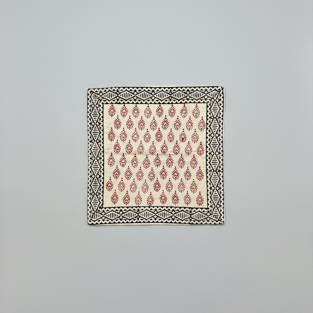 Patterned fabric square cushion cover in Bagru hand block print on a light gray background