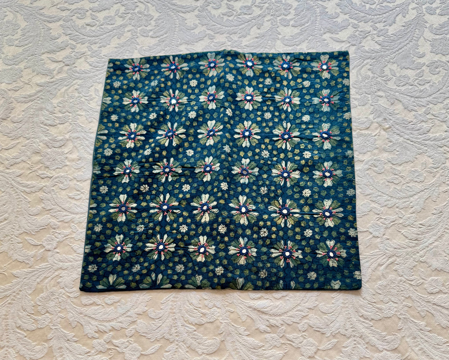 Floral patterned hand block printed cushion cover  on a textured white background