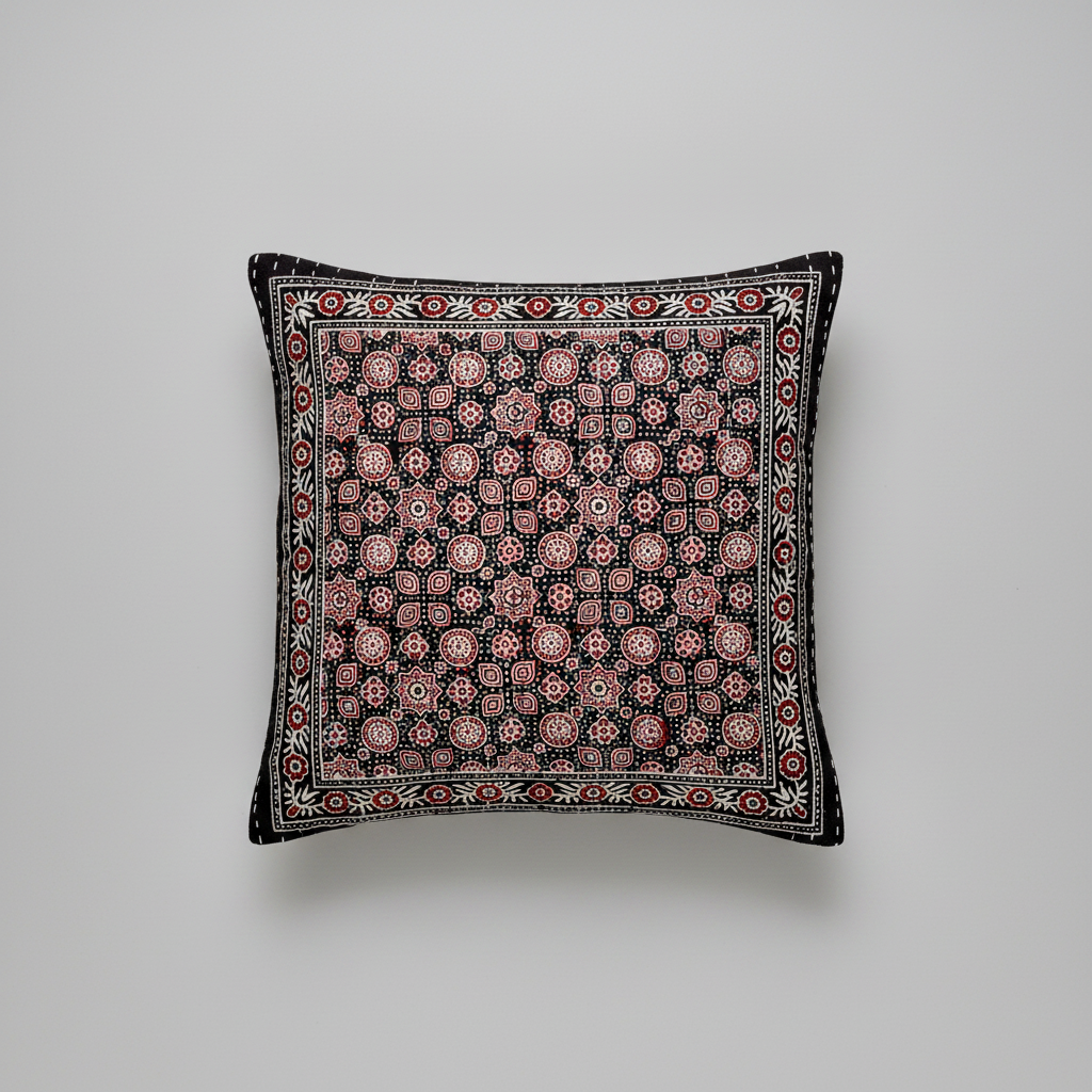Decorative pillow with intricate Ajrakh hand block print pattern on a gray background