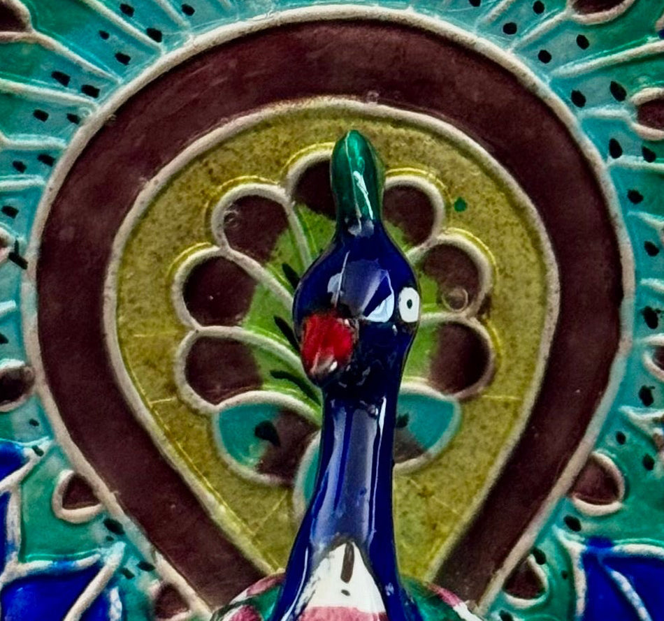 Decorative Gulabi Meenakari silver  peacock sculpture on a stand with a neutral background