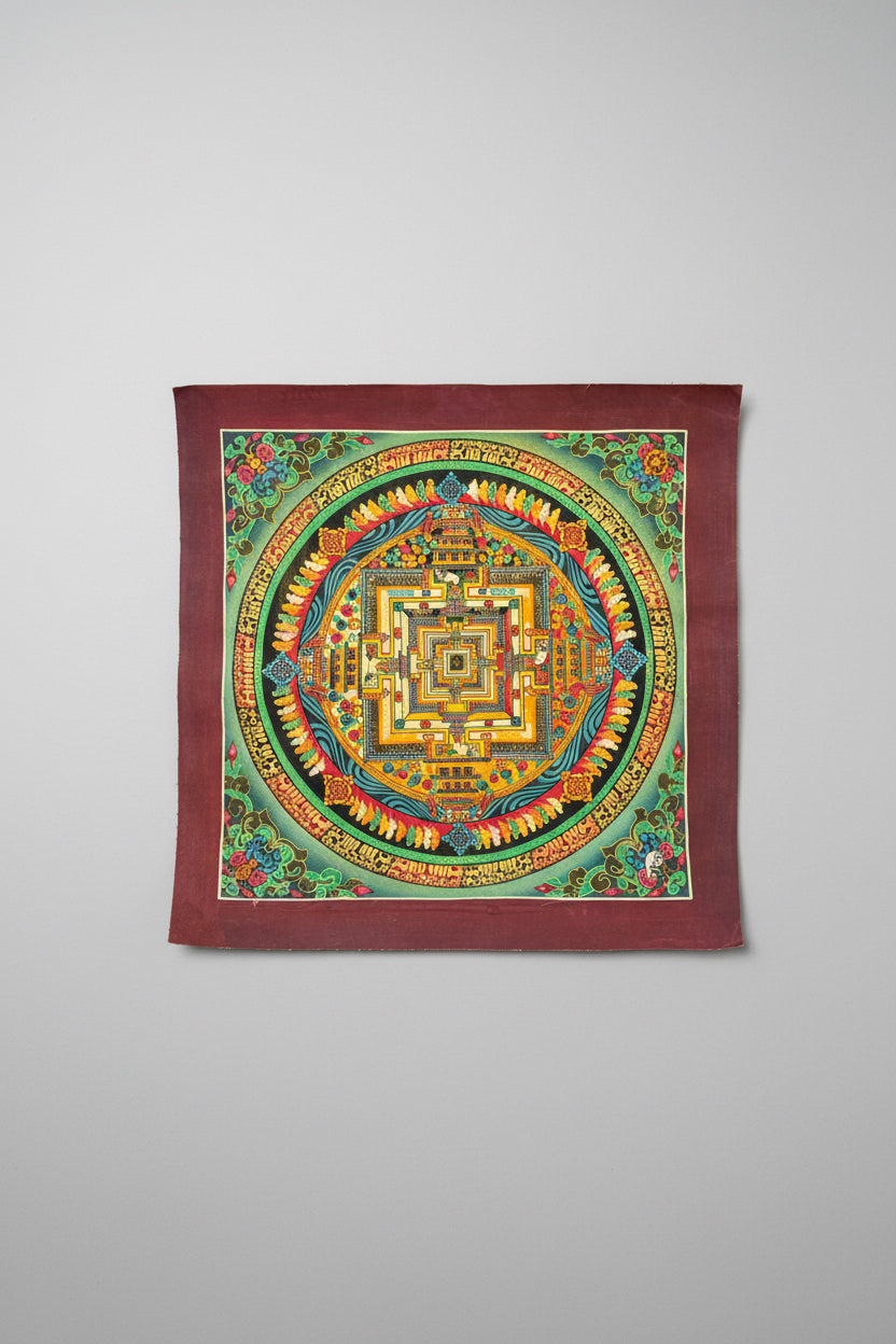 Colorful mandala design in Thangka art style on a gray surface