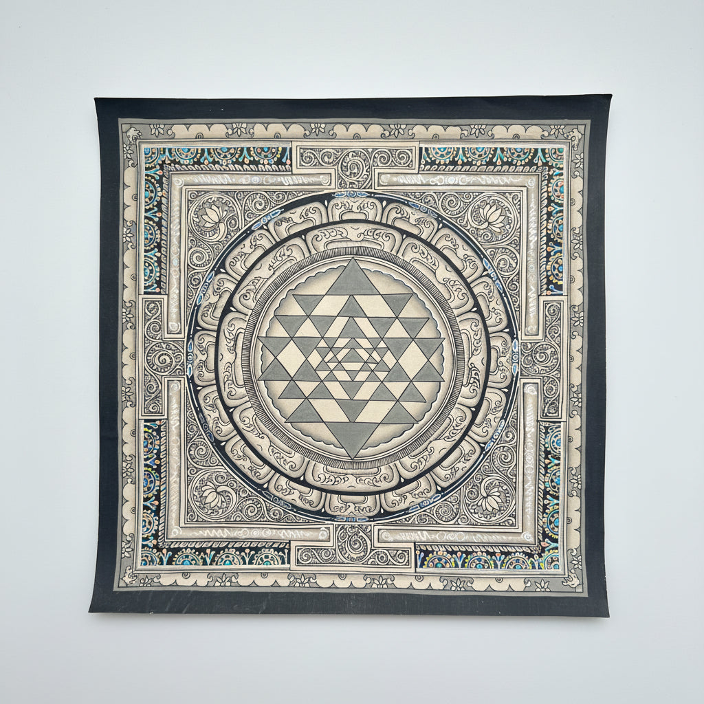 Shree yantra painting in Thangka art style with a geometric design on a dark surface