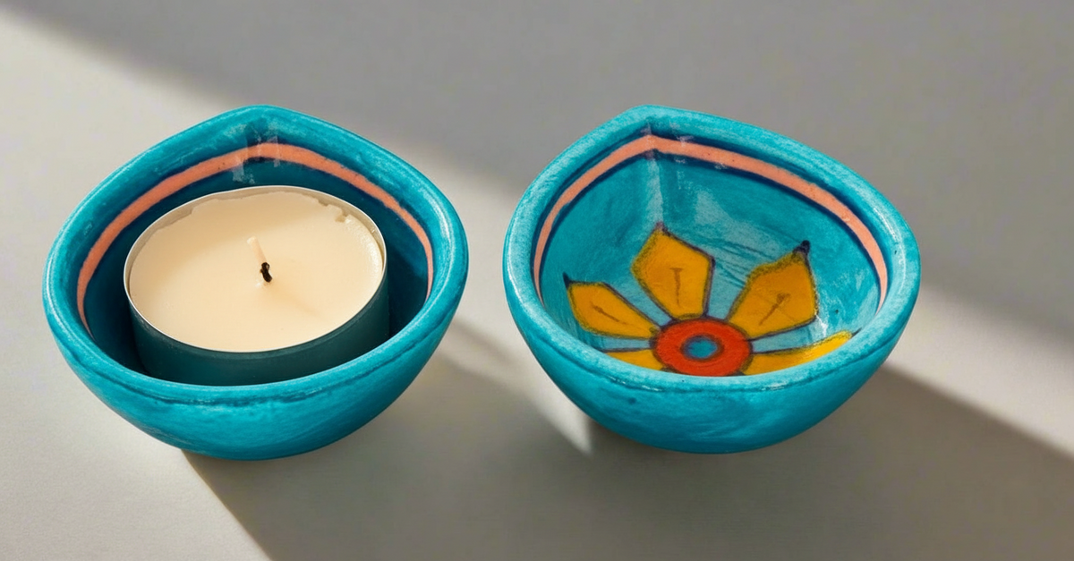 Two turquoise ceramic bowls with floral designs on a light gray background