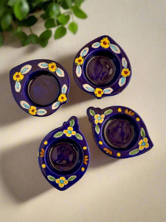 Handcrafted Jaipur Blue Pottery tea light holders, featuring intricate designs and vibrant blue hues, adding a traditional Indian touch to your home decor.