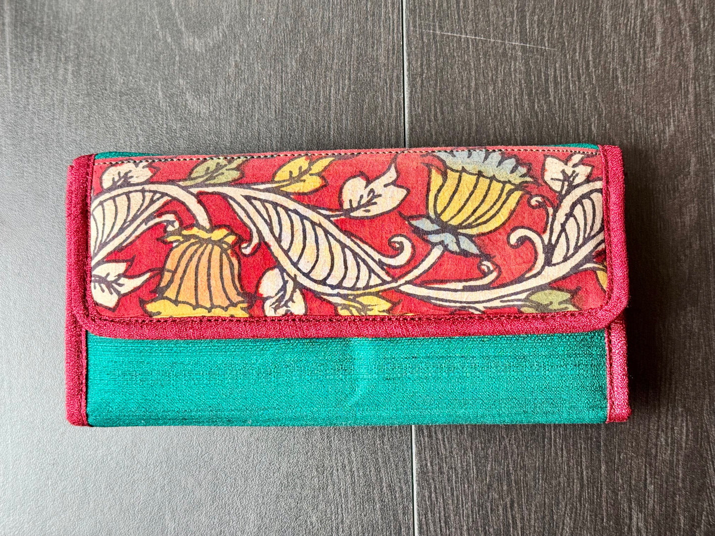 Authentic Kalamkari fabric evening clutch featuring vibrant hand-painted Indian motifs and artisanal detailing. Front of the clutch