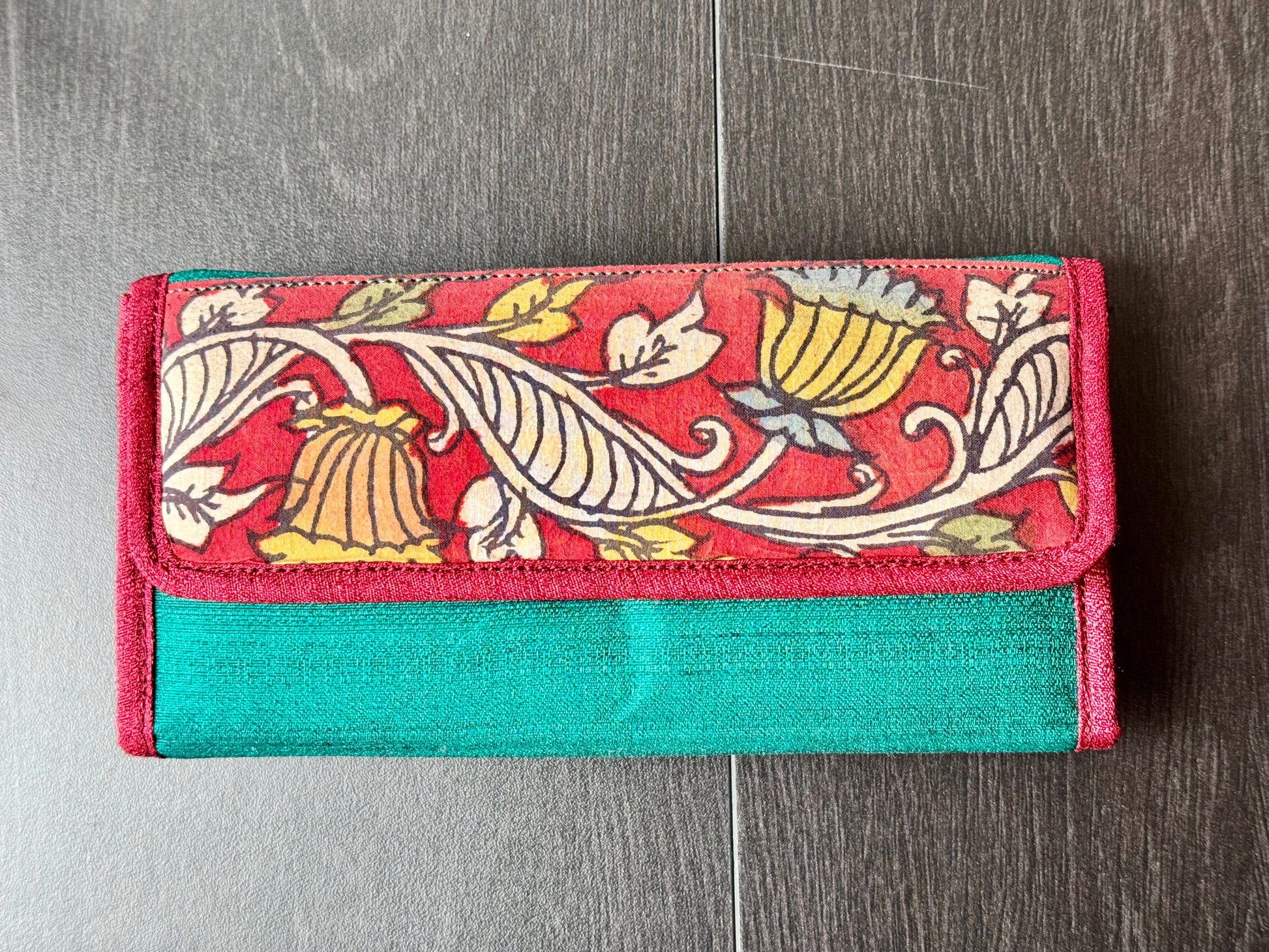 Authentic Kalamkari fabric evening clutch featuring vibrant hand-painted Indian motifs and artisanal detailing. Front of the clutch