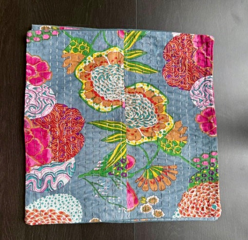 Colorful floral-patterned fabric on a dark surface