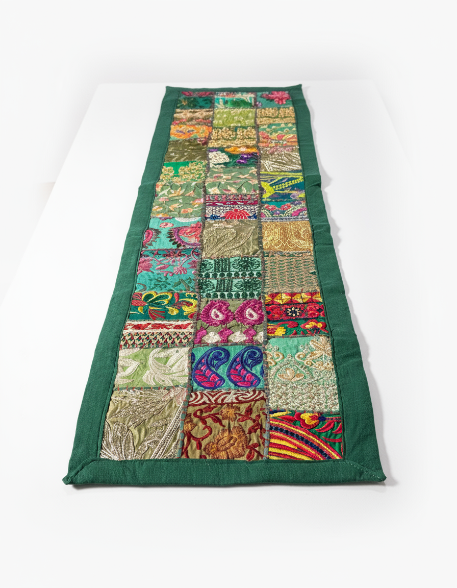 Colorful patchwork table runner with green border on a white background