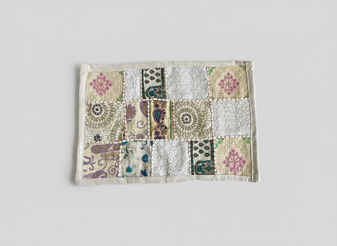 Patchwork placemats with floral and geometric patterns on a light gray background
