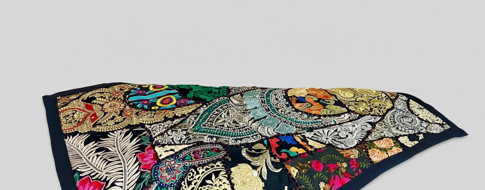 Colorful embroidered fabric with intricate patterns on a light gray background
