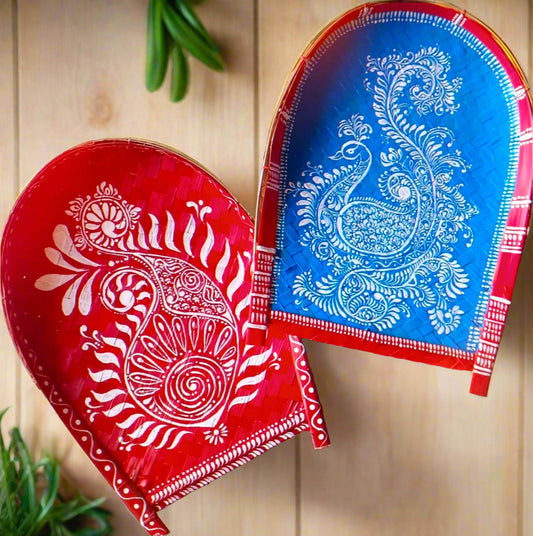 Hand-painted Alpona art on Kulo baskets, featuring intricate Bengali motifs in traditional, flowing patterns.