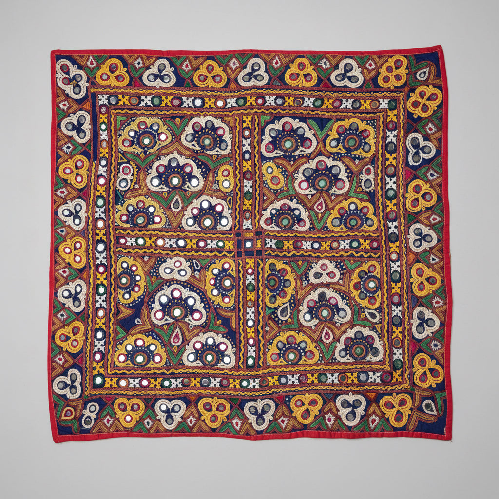 Colorful Kutchi embroidered textile with geometric and floral patterns on a plain background