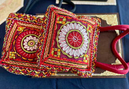 Handcrafted Kutchi embroidery bags and purses featuring intricate needlework, vibrant patterns, and traditional Indian craftsmanship.