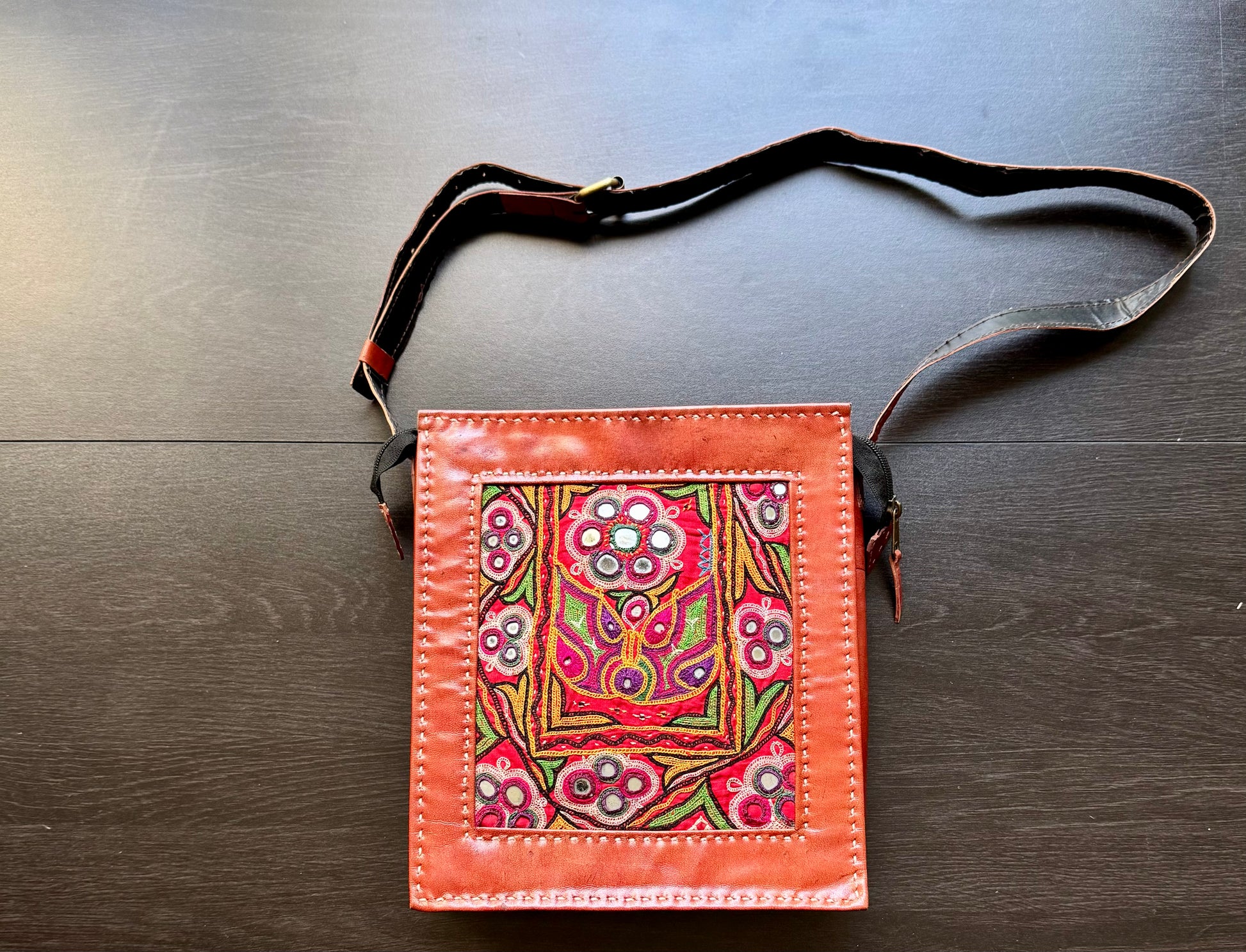 Kutchi leather rectangular sling bag with Kutchi embroidered surface. 