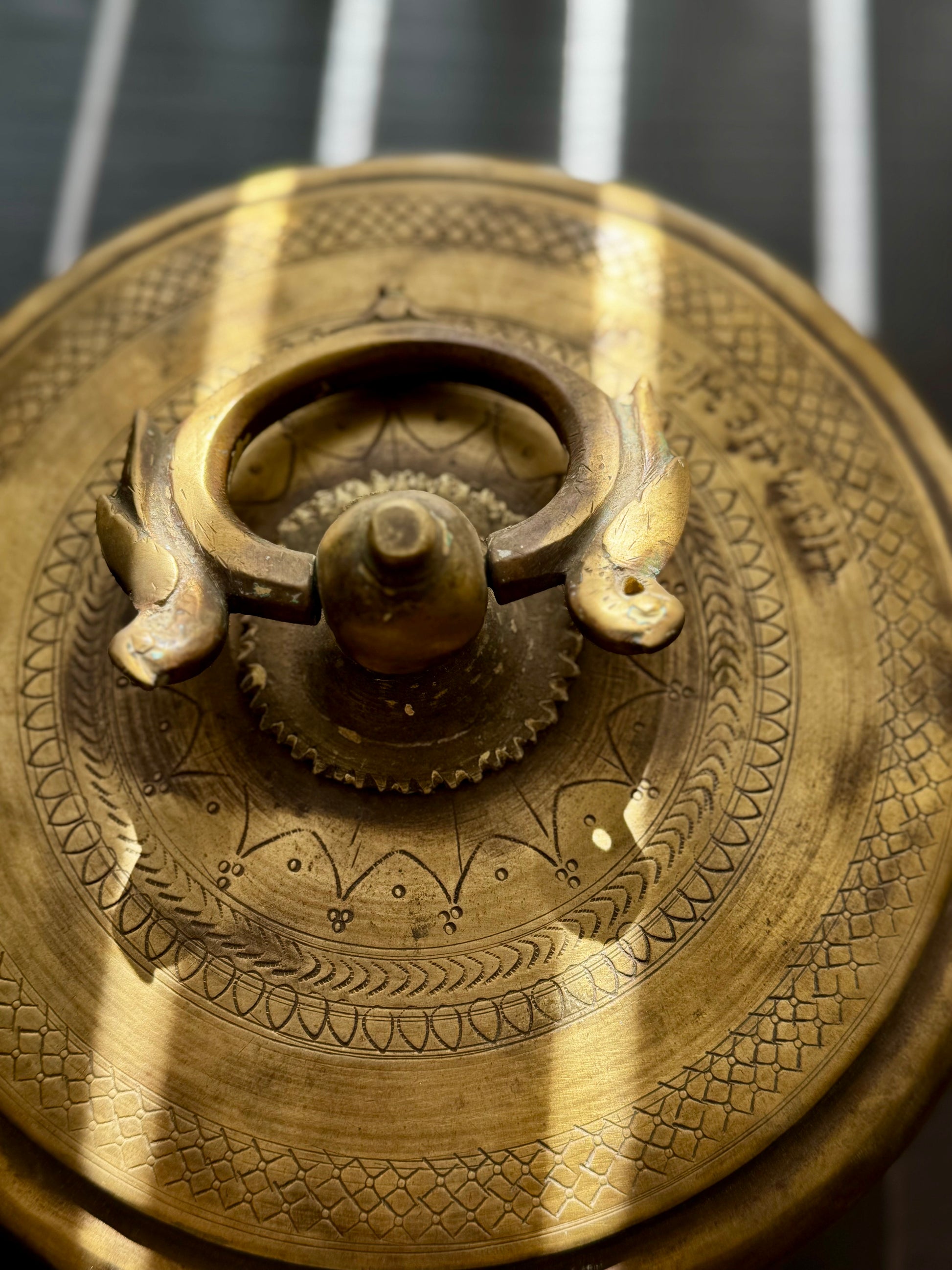 Close-up of a brass decorative object with intricate patterns