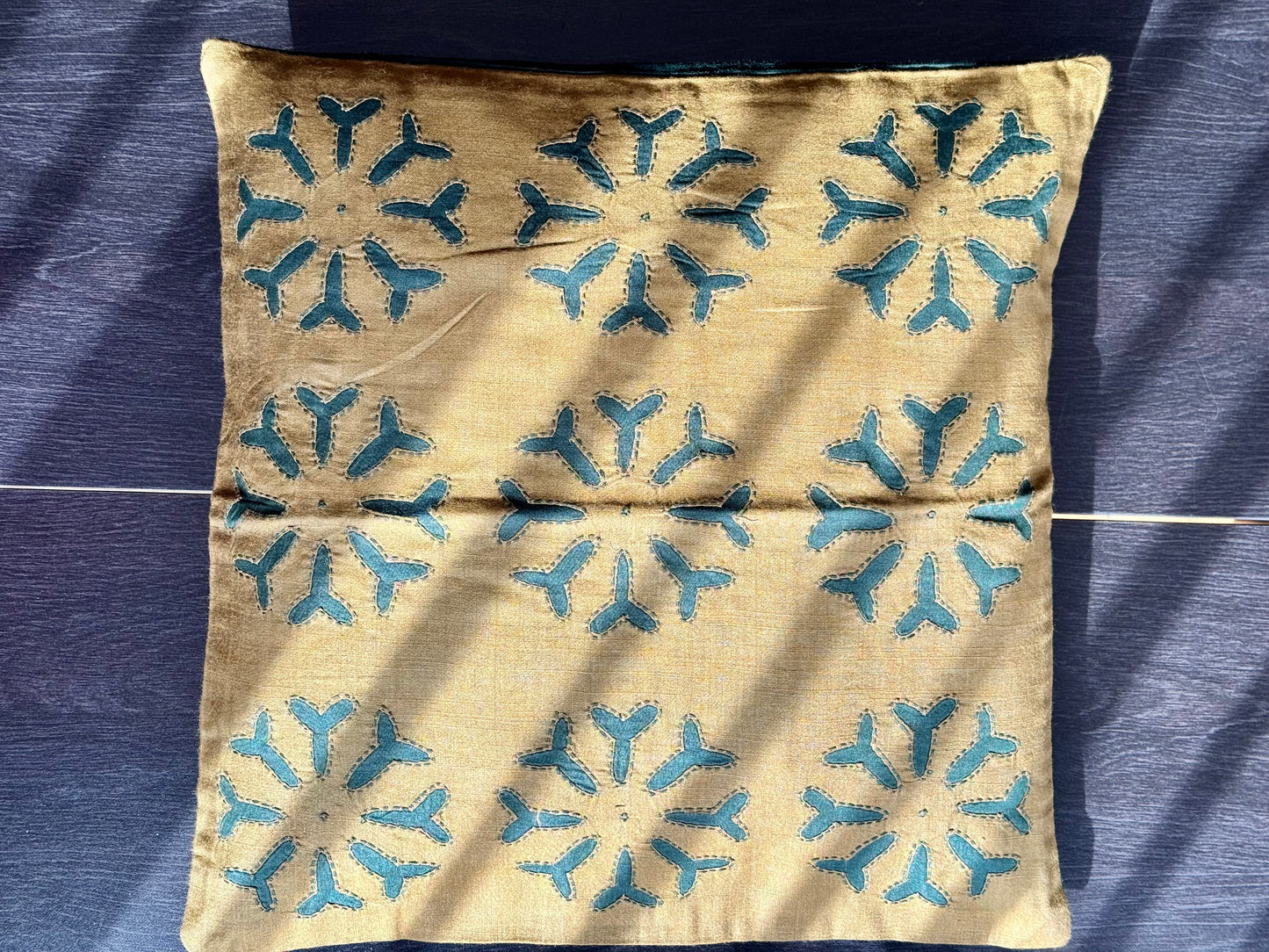 Handcrafted Appliqué work on cushion covers, showcasing vibrant designs and intricate stitching. A beautiful fusion of traditional craftsmanship and modern style, adding a unique touch to your living space.