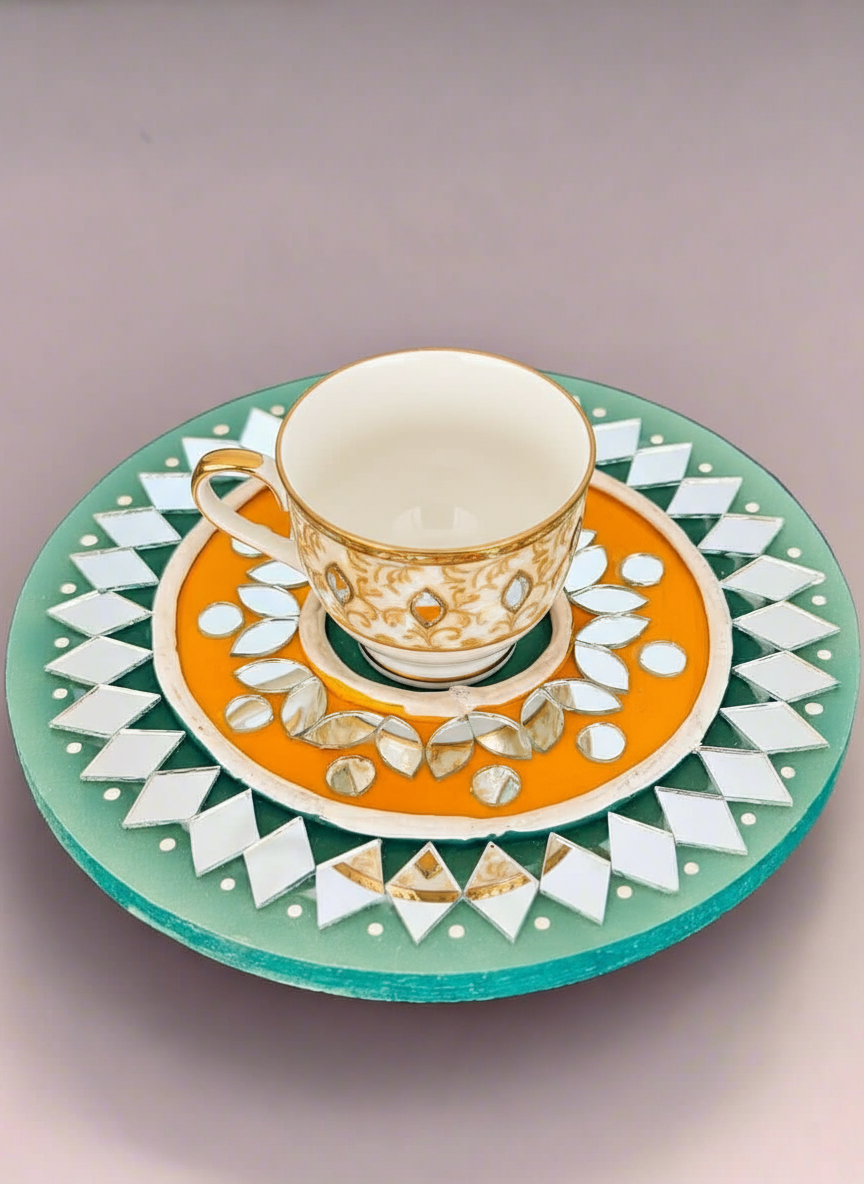 Decorative teacup and saucer with geometric patterns on a light gray background